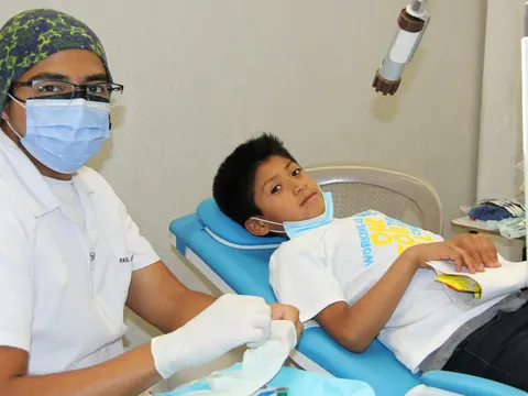 Dentist with a young patient in the chair